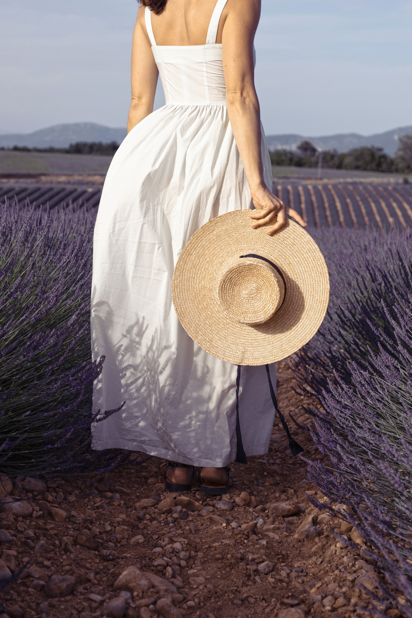 woman in a white dress surrounded by lavender